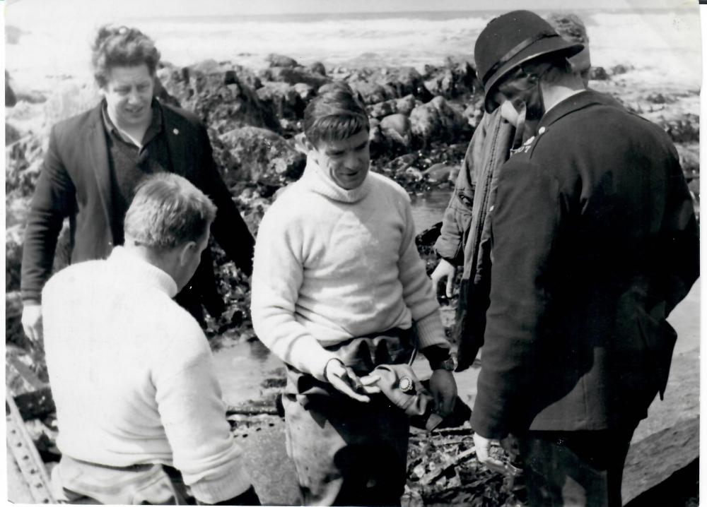 Bomb unit comb wreck after AA shell cases are washed up