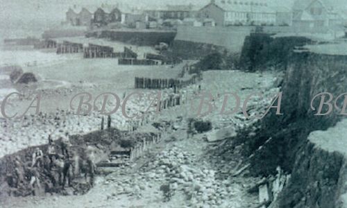 58   groynes damaged shoreline men working