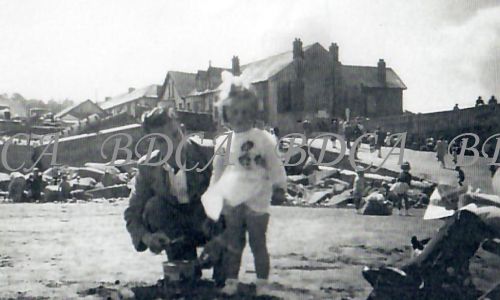 58 .4  man with child slipway beach